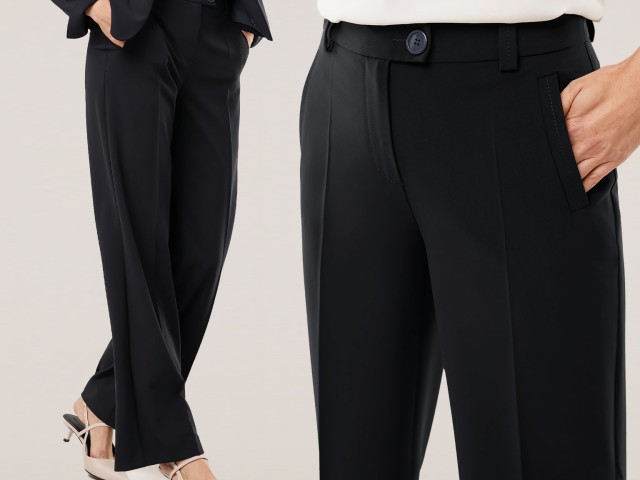 Person trägt schwarze Hose mit grünem geometrischem Muster, sitzt auf einer Bank.