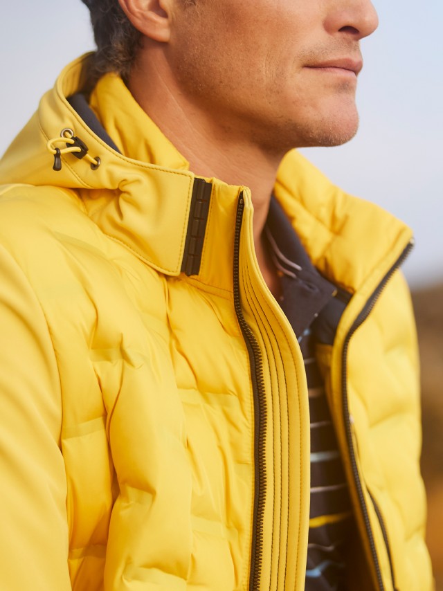 Mann trägt eine gelbe Jacke mit Klimakammern