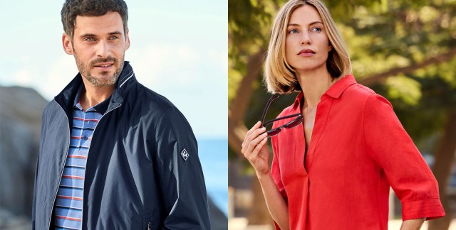 Mann an einer Felsküste in marineblauem Blouson und gestreiftem Polo und Frau in signalrotem Leinenmixkleid trägt eine Sonnenbrille in der Hand