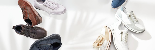 Verschiedene Sneaker in diversen Farben sind auf einem hellen Hintergrund angeordnet.
